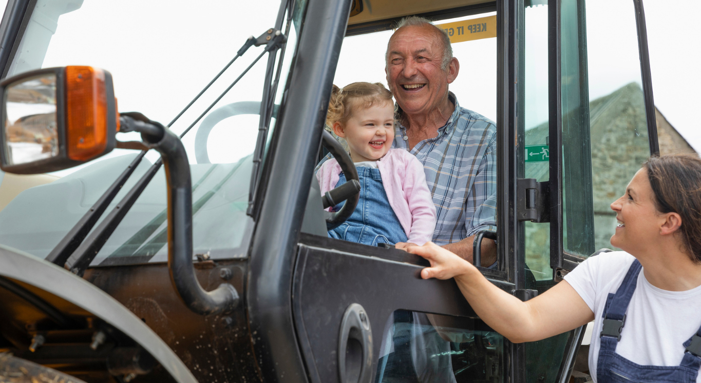 Grandpa and Child smiling on tractor