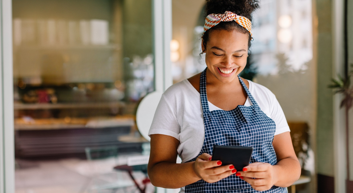 Business owner smiling looking at a tablet